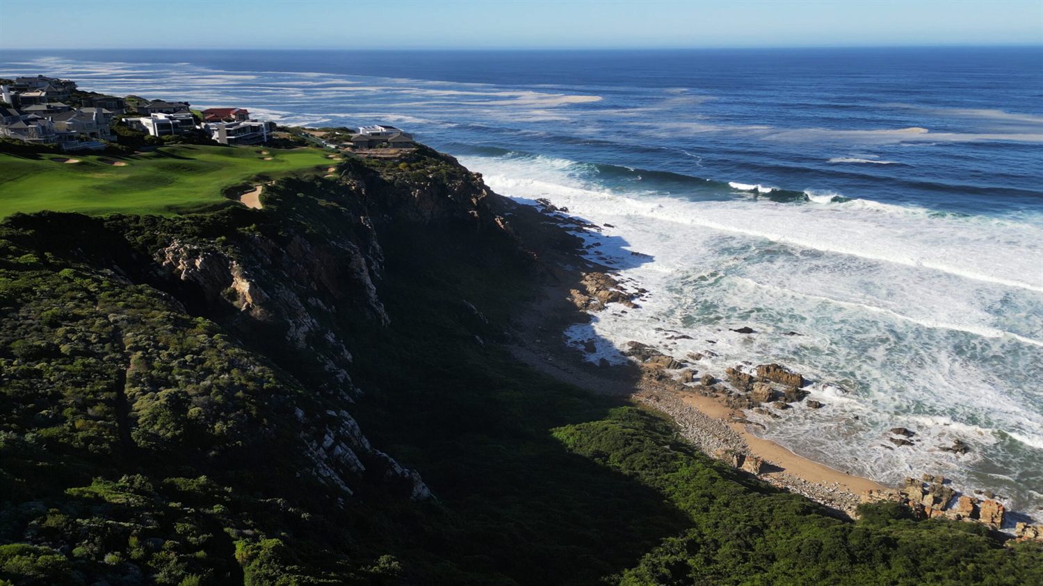 A clifftop hole at Pinnacle Point above the Indian Ocean at sunset